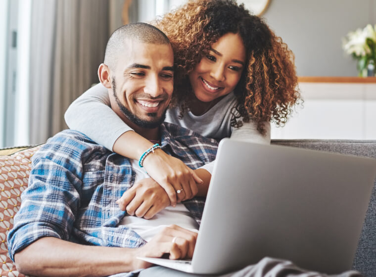 happy couple looking at computer