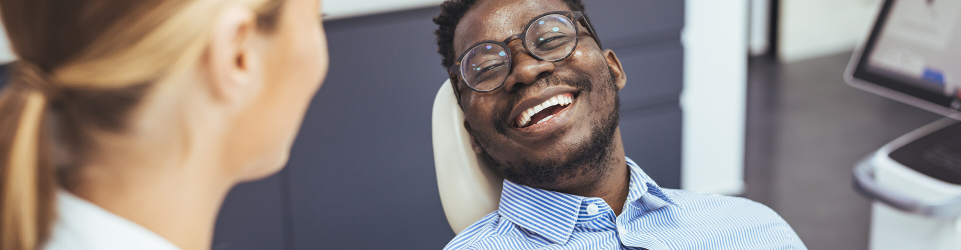 "man smiling in a dentist chair"